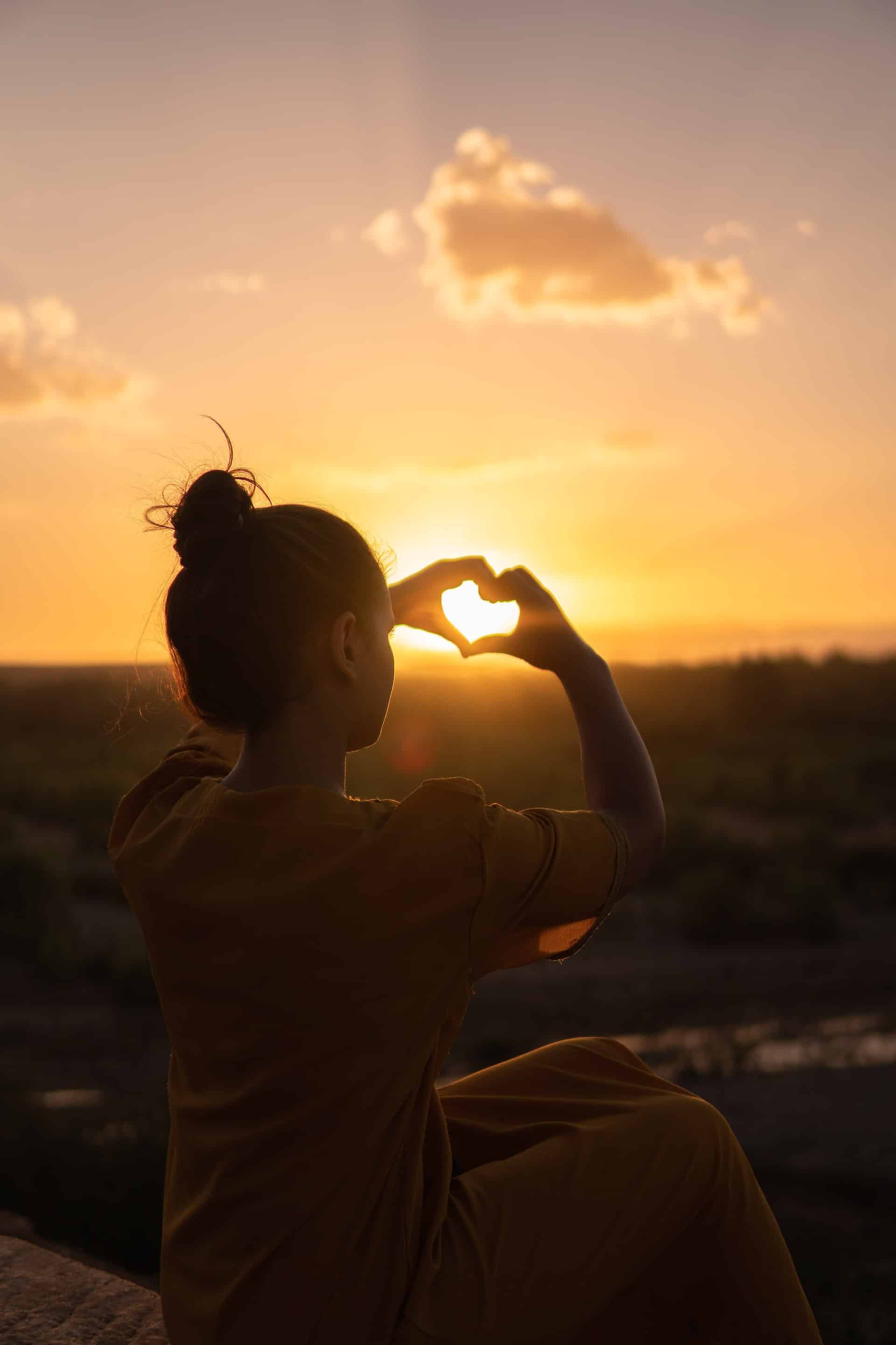 young woman making hands with heart